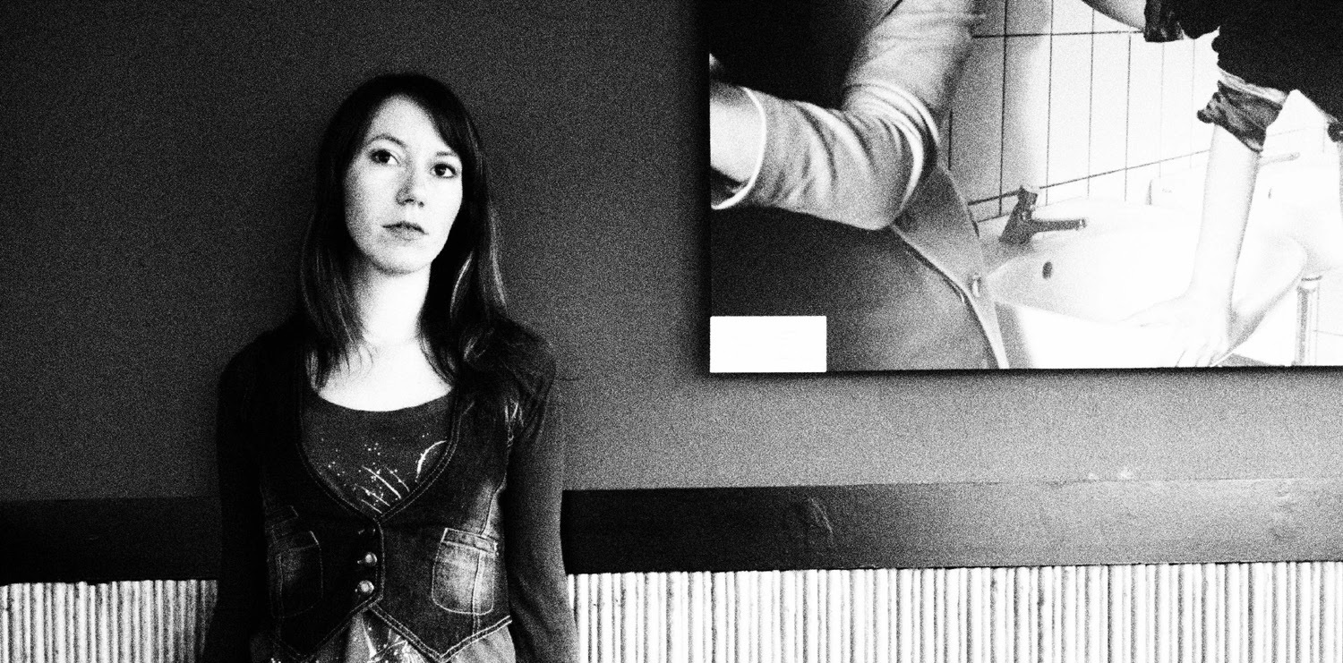The artist Sadness Theory standing against the wall