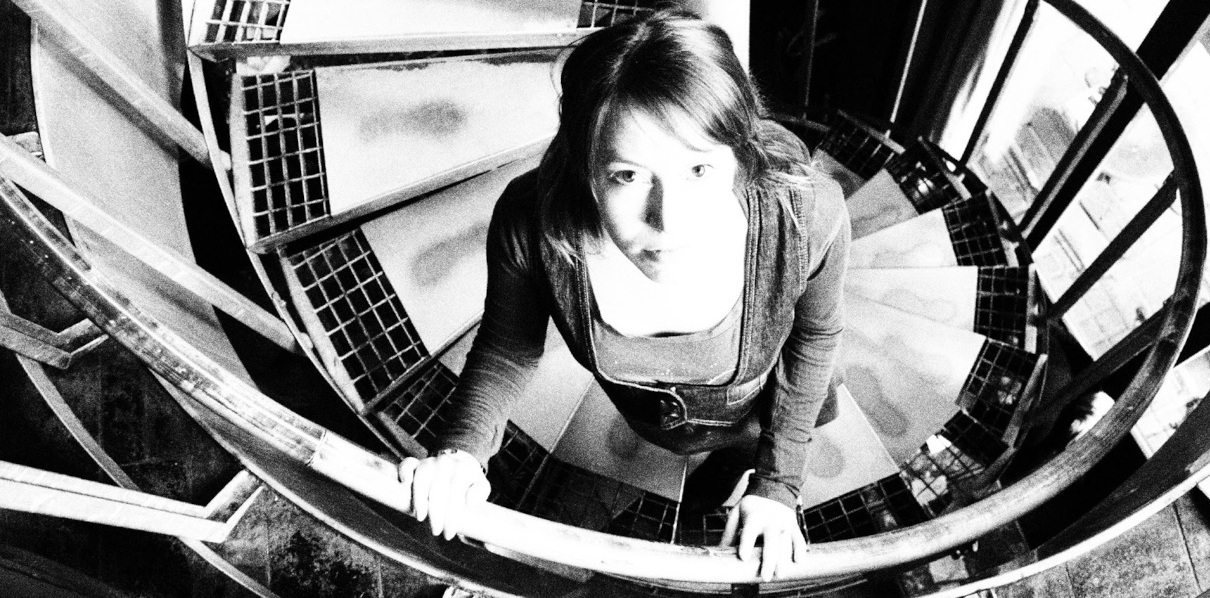 The artist Sadness Theory standing on the stairs
