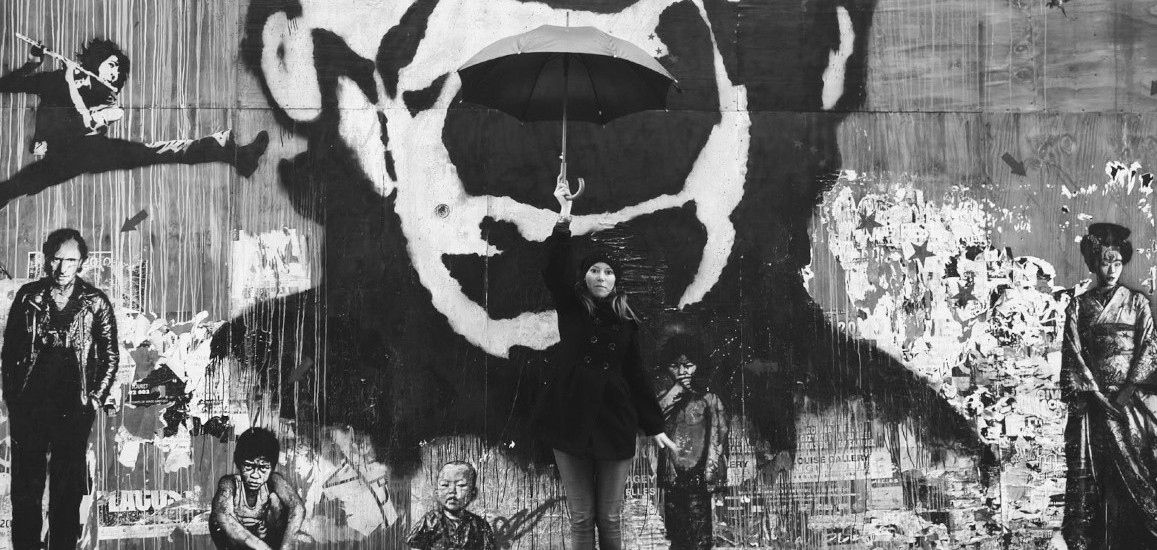 The artist Sadness Theory holding an umbrella
